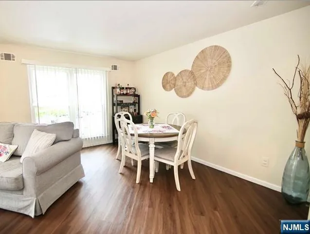 a dining room with furniture and wooden floor