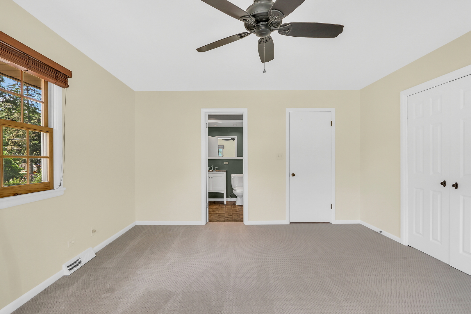 219 East Rockland Road Libertyville, IL 60048 - Photo 15 of 23 an empty room with closet and a ceiling fan