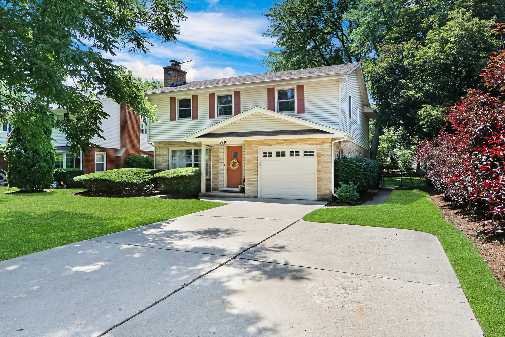 219 East Rockland Road Libertyville, IL 60048 - Photo 2 of 23 a front view of a house with a yard and trees