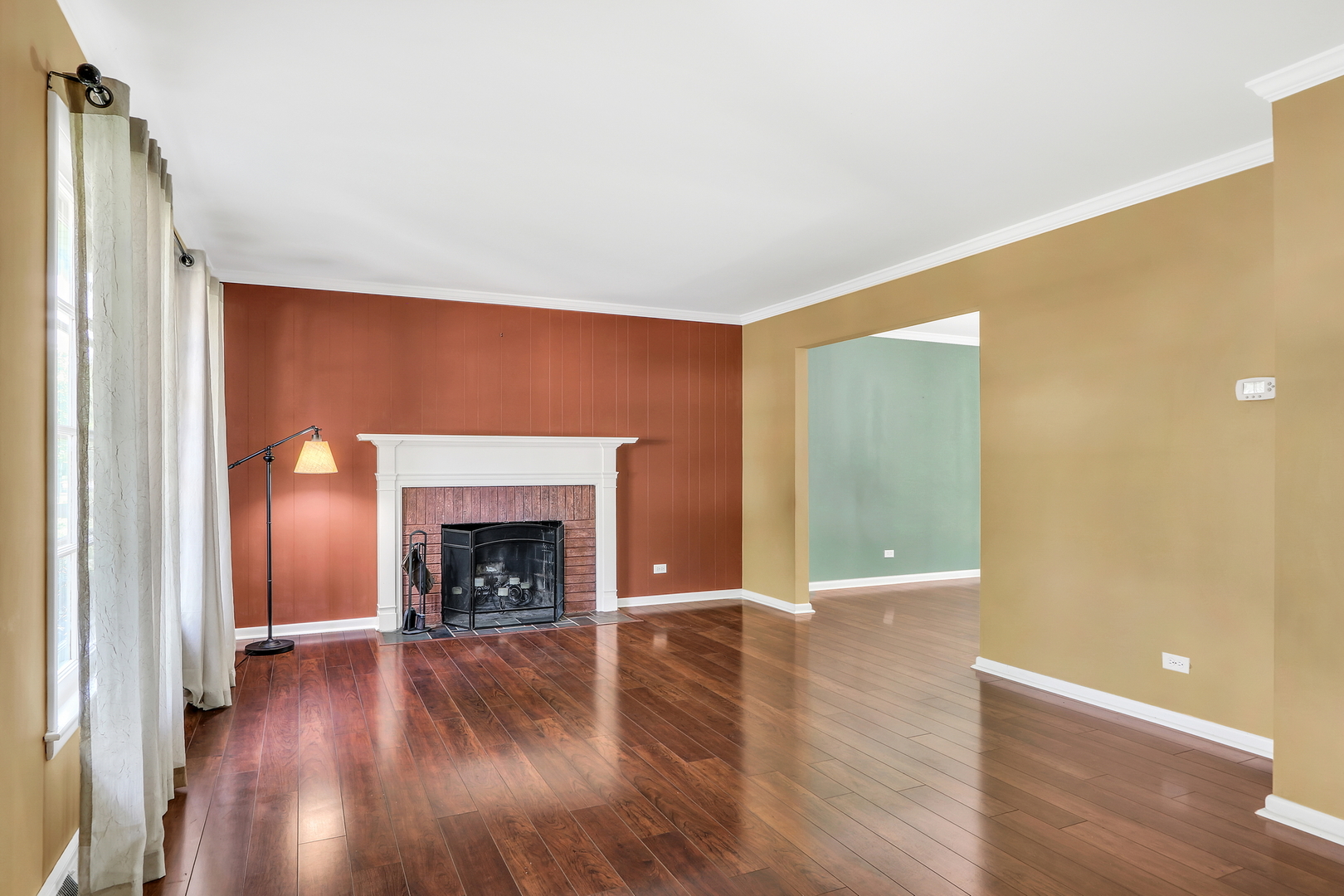 219 East Rockland Road Libertyville, IL 60048 - Photo 4 of 23 a view of an empty room with wooden floor fireplace and a window