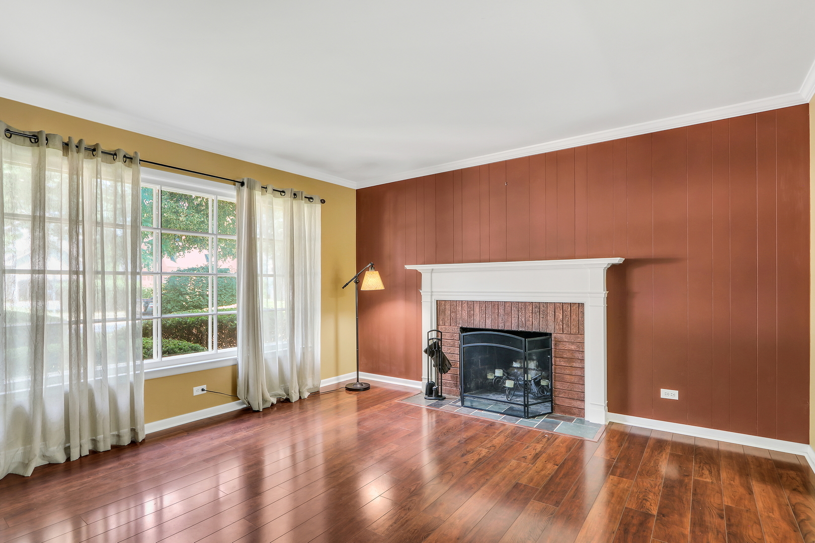 219 East Rockland Road Libertyville, IL 60048 - Photo 5 of 23 a view of an empty room with wooden floor fireplace and a window