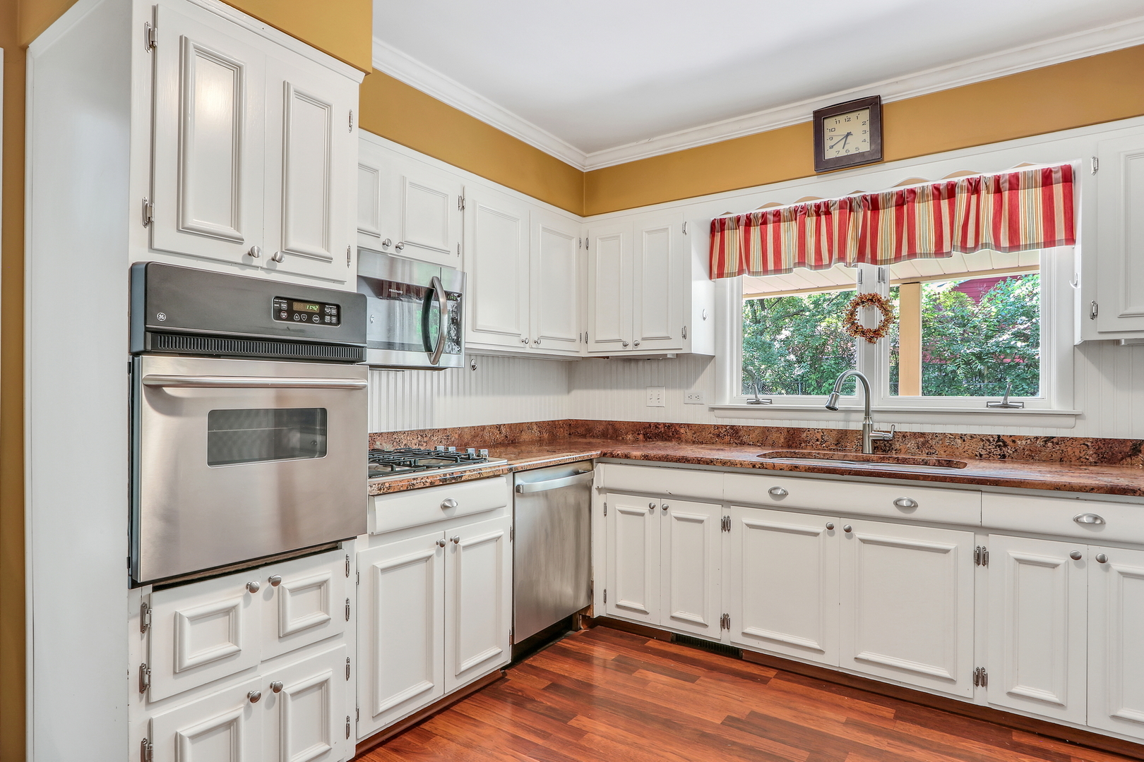 219 East Rockland Road Libertyville, IL 60048 - Photo 9 of 23 a kitchen with stainless steel appliances granite countertop a stove and a sink