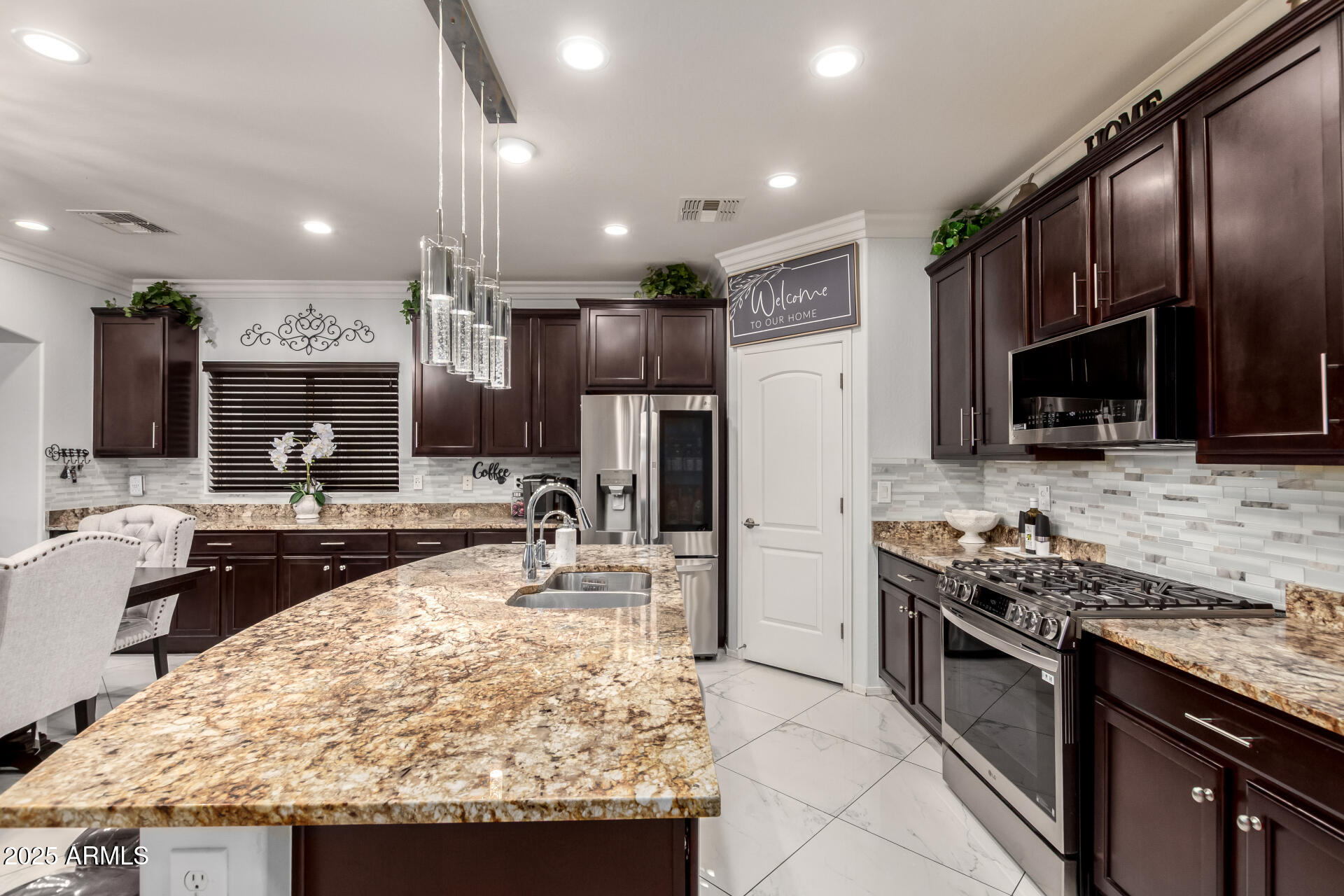 6641 West Georgetown Way Florence, AZ 85132 - Photo 12 of 35 a kitchen with stainless steel appliances granite countertop a sink stove and refrigerator