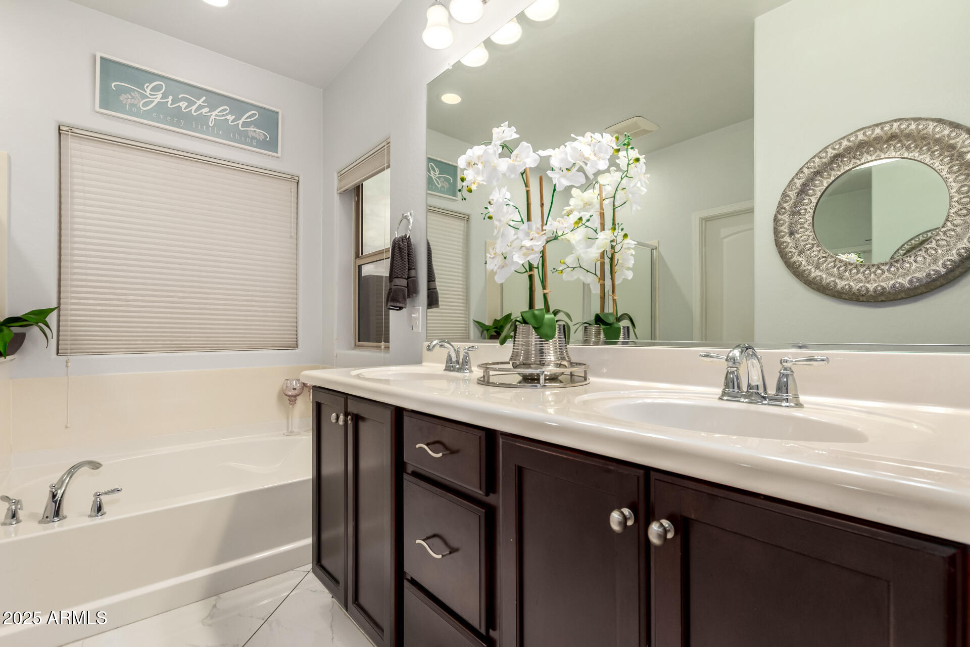 6641 West Georgetown Way Florence, AZ 85132 - Photo 18 of 35 a bathroom with a granite countertop sink a large mirror and a bathtub