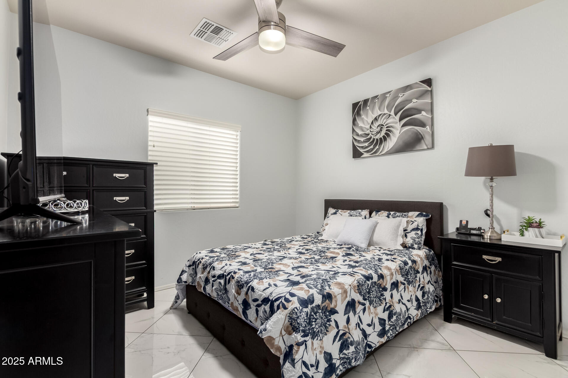 6641 West Georgetown Way Florence, AZ 85132 - Photo 25 of 35 a bedroom with a bed and a lamp on dresser