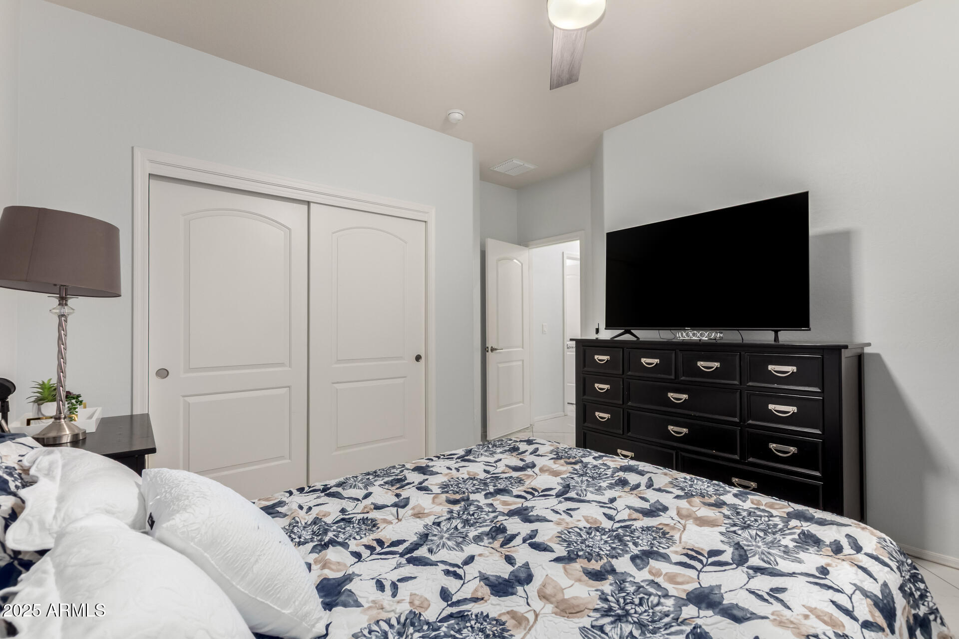 6641 West Georgetown Way Florence, AZ 85132 - Photo 26 of 35 a bedroom with a bed and a flat screen tv