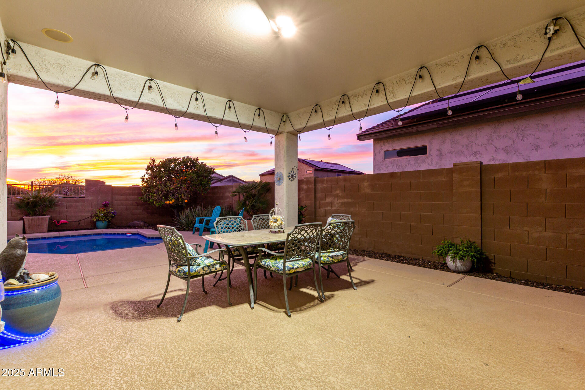 6641 West Georgetown Way Florence, AZ 85132 - Photo 29 of 35 a view of a patio with a dining table and chairs with wooden floor