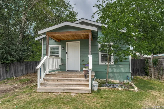 a front view of a house with a garden