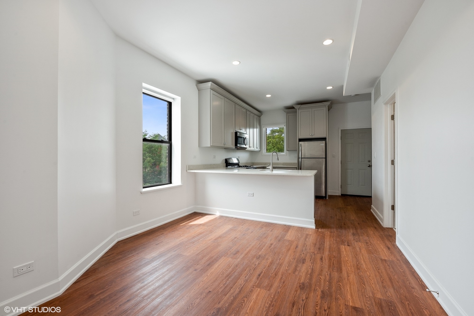 6036 North Broadway, Unit 3 Chicago, IL 60660 - Photo 2 of 17 a view of kitchen with granite countertop cabinets and wooden floor