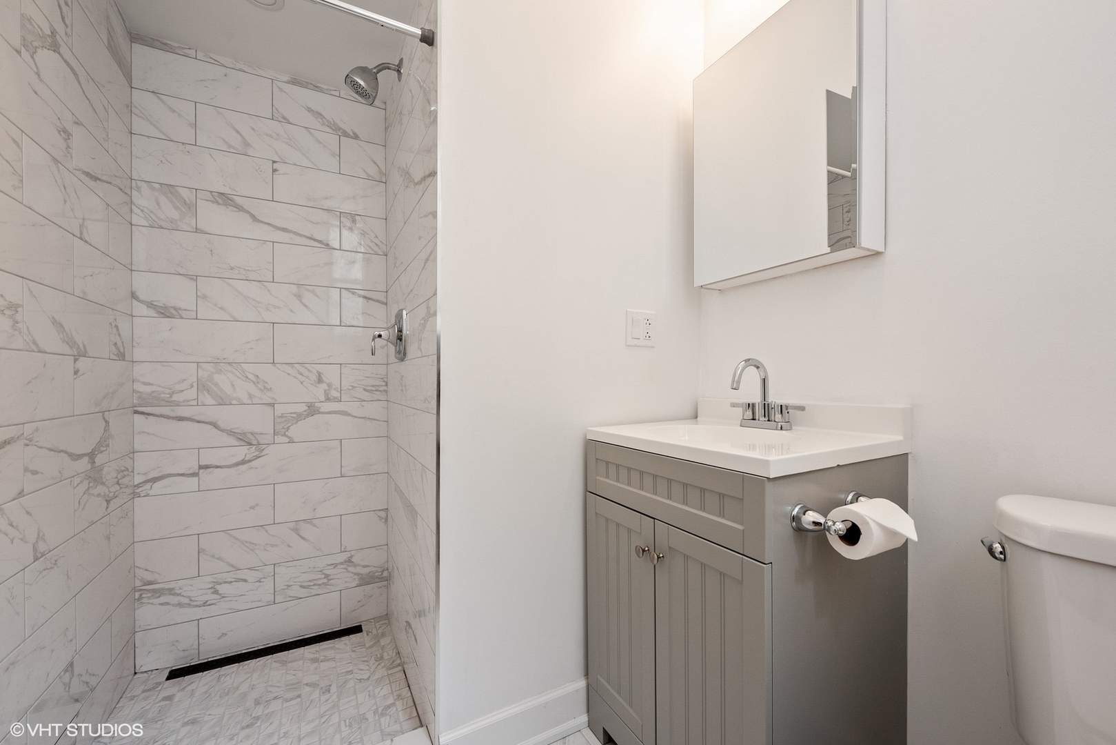 6036 North Broadway, Unit 3 Chicago, IL 60660 - Photo 15 of 17 a bathroom with a sink a toilet and mirror