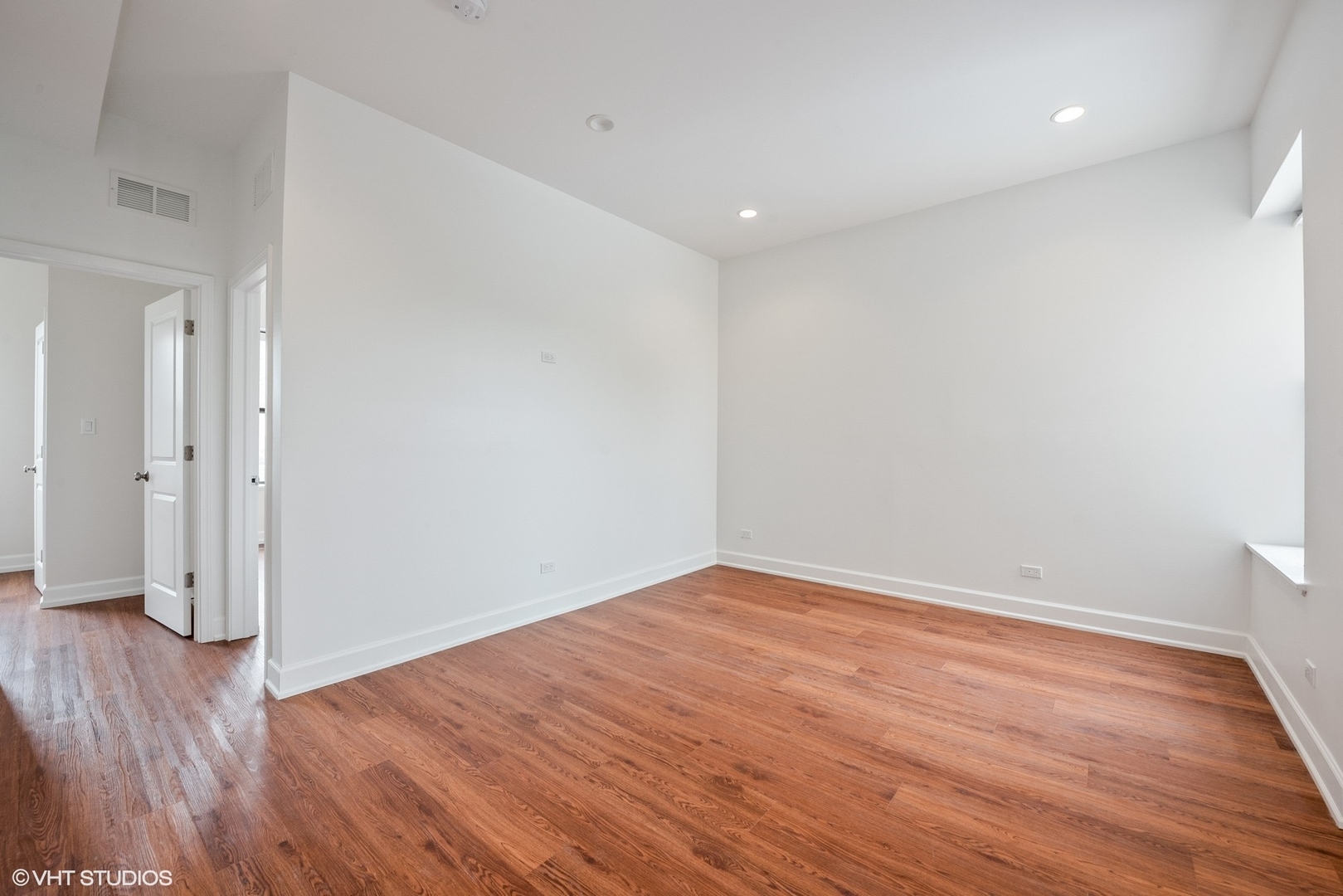 6036 North Broadway, Unit 3 Chicago, IL 60660 - Photo 4 of 17 an empty room with wooden floor