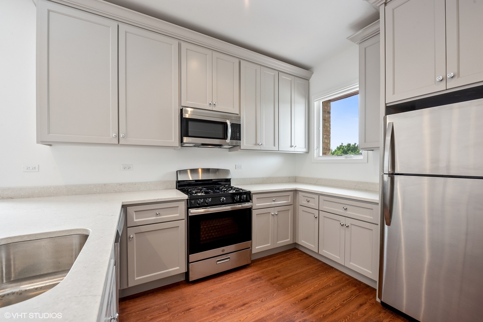 6036 North Broadway, Unit 3 Chicago, IL 60660 - Photo 7 of 17 a kitchen with a sink stove and refrigerator