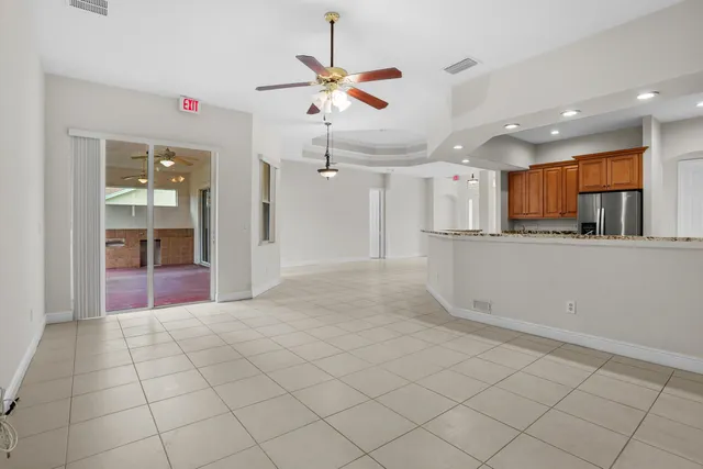 a view of a kitchen with a sink and a refrigerator