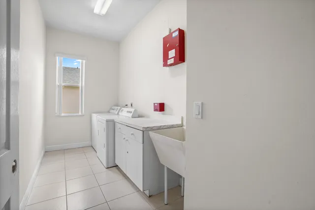 a utility room with a sink dryer and washer