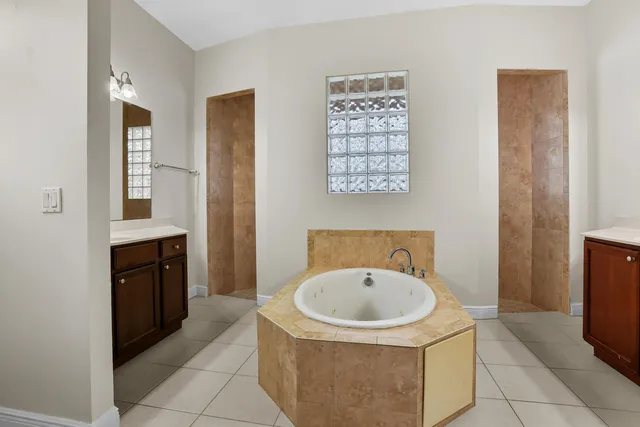 a bathroom with a sink a bathtub and mirror