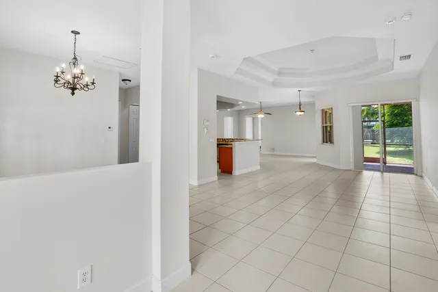 a view of a hallway with chandelier