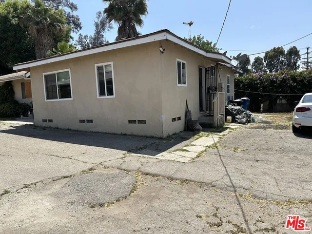 a view of a house with wooden fence