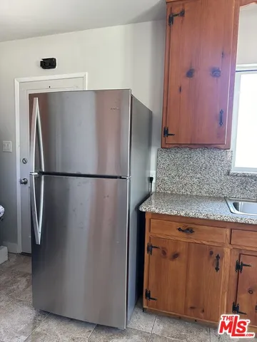 a kitchen with metallic refrigerator freezer and a dishwasher