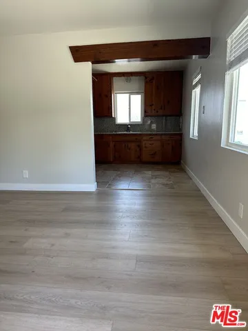 a view of wooden floor and windows in a room