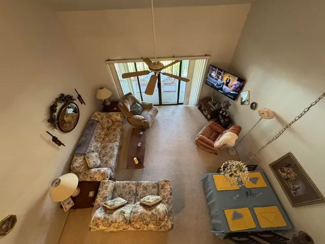 a view of living room with furniture and a floor to ceiling window