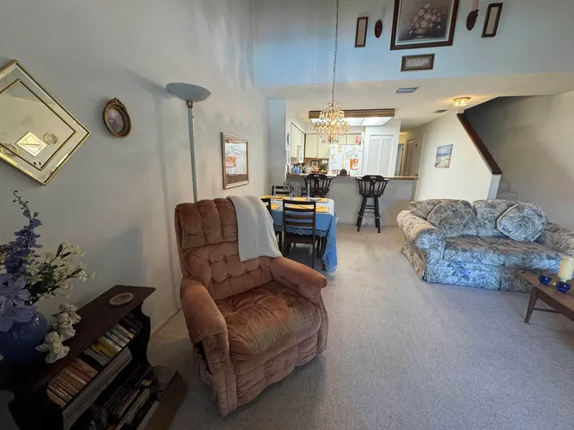 a living room with furniture and a clock