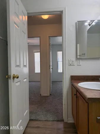 a bathroom with a granite countertop sink and a mirror