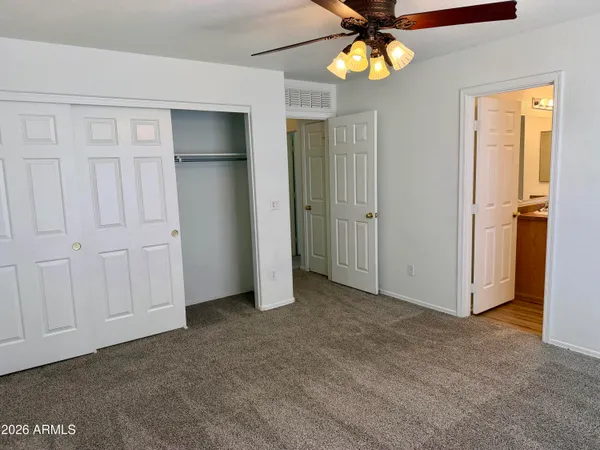 a view of a livingroom with a chandelier fan