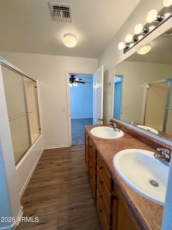 a bathroom with a sink double vanity and a mirror