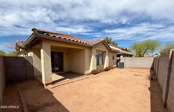 a view of a house with wooden fence