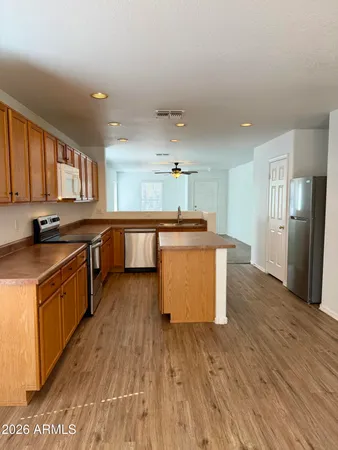 a large kitchen with stainless steel appliances granite countertop a large stove a sink dishwasher and a refrigerator