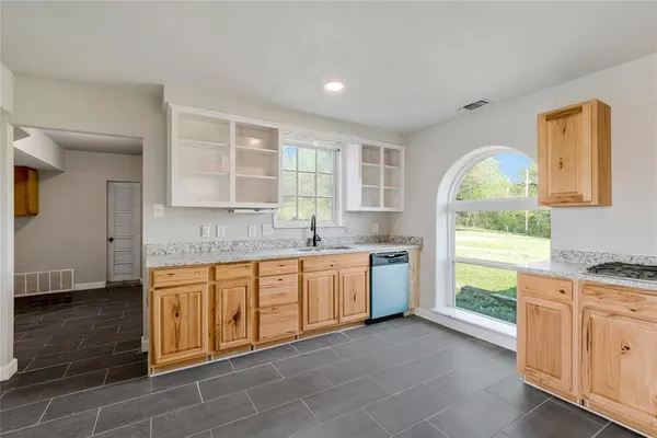 a spacious bathroom with a granite countertop sink a mirror and a bathtub