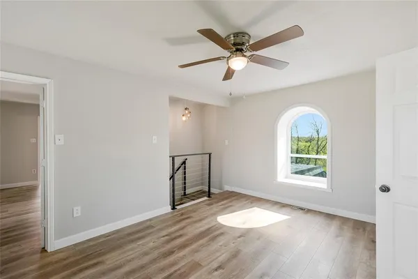 wooden floor in an empty room with a window