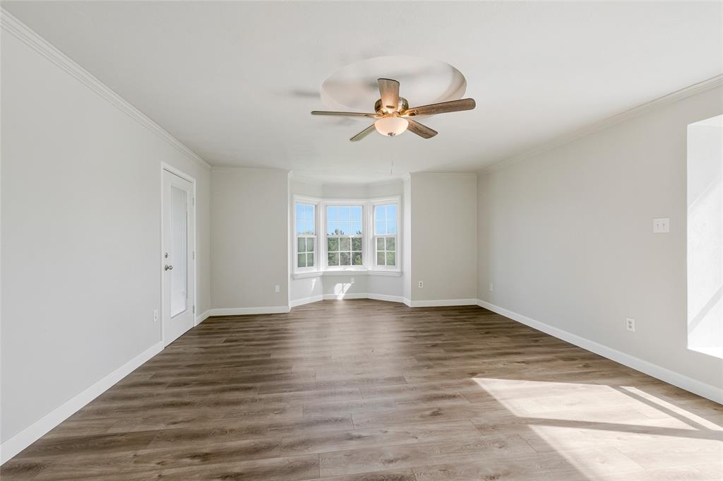 41 Kelsey Road Denison, TX 75021 - Photo 16 of 31 Massive primary bedroom with private balcony, and room for a seating area near bay window.