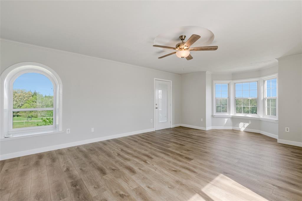 41 Kelsey Road Denison, TX 75021 - Photo 17 of 31 a view of empty room with wooden floor and fan