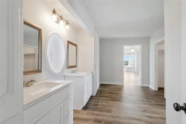 a spacious bathroom with a double vanity sink and a mirror