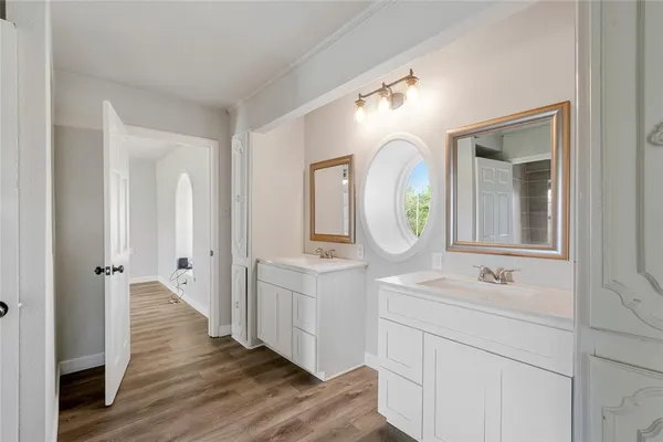 a bathroom with a double vanity sink and a mirror