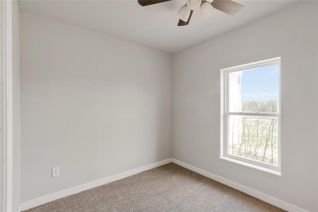 41 Kelsey Road Denison, TX 75021 - Photo 24 of 31 Secondary bedroom with ceiling fan and new carpet.