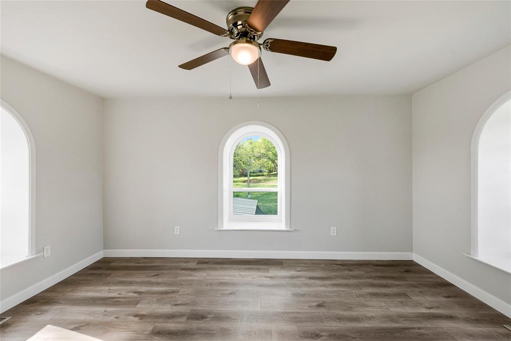 41 Kelsey Road Denison, TX 75021 - Photo 25 of 31 Upstairs secondary bedroom with ceiling fan and new luxury vinyl flooring.