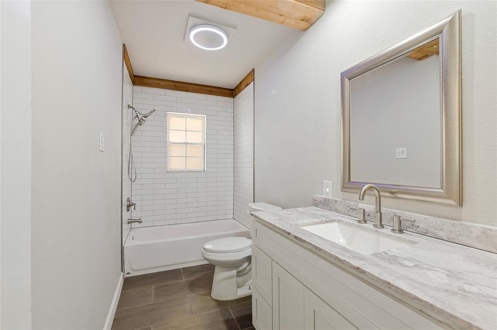 41 Kelsey Road Denison, TX 75021 - Photo 26 of 31 Guest bathroom with new vanity, flooring, and toilet.