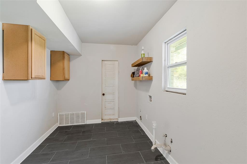 41 Kelsey Road Denison, TX 75021 - Photo 27 of 31 Large laundry room with two washing machine hookups, space for a freezer, and access to workshop in garage.