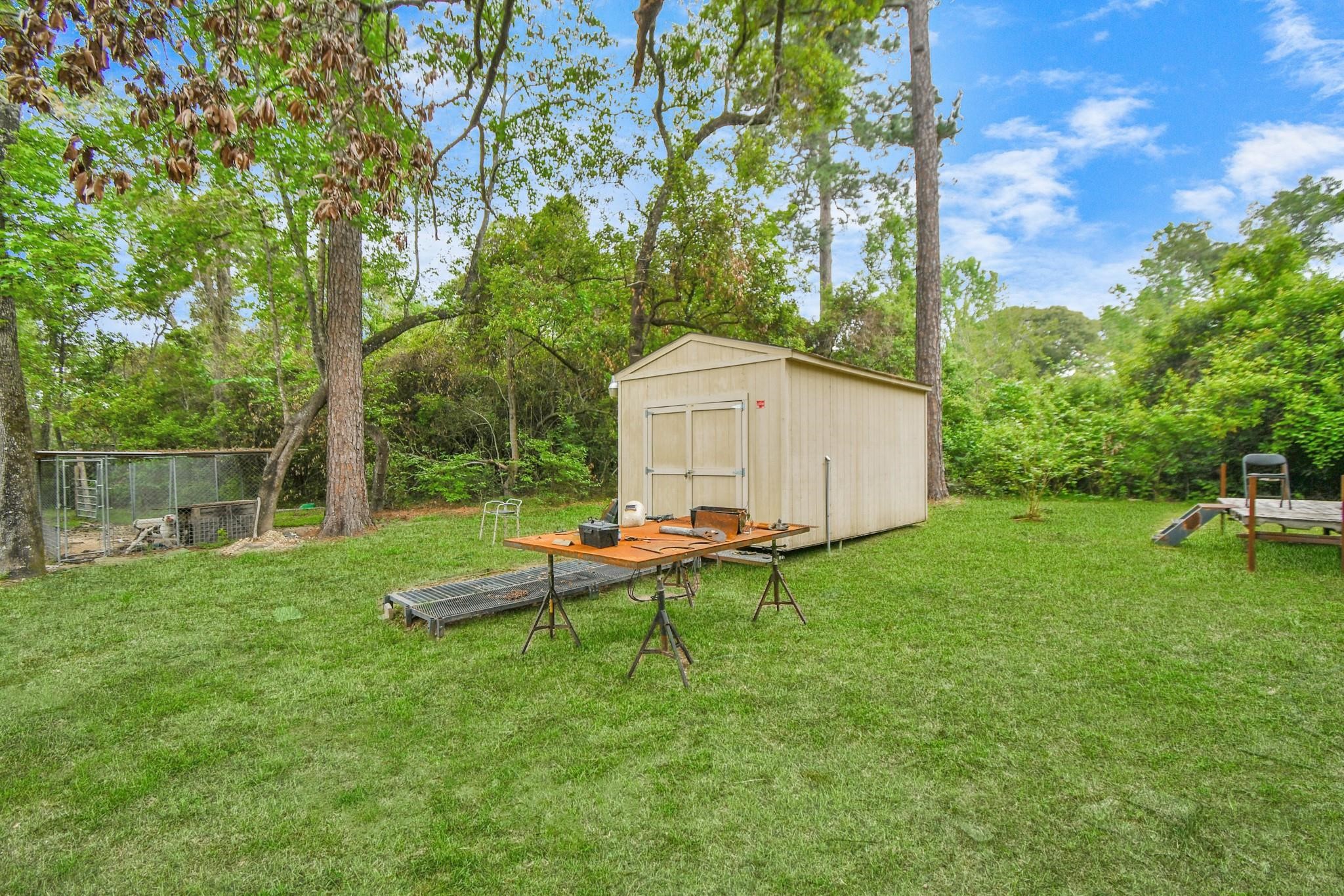 24998 Sorters Road Porter, TX 77365 - Photo 16 of 39 a backyard of a house with table and chairs