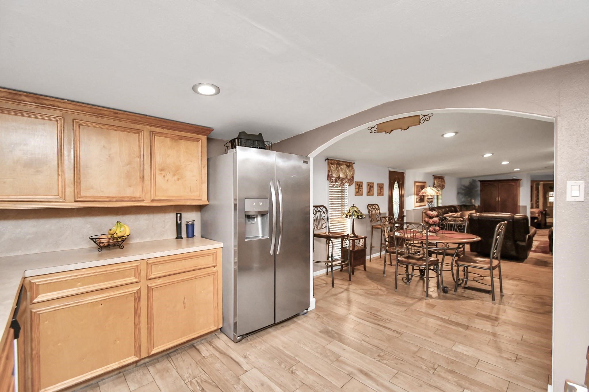 24998 Sorters Road Porter, TX 77365 - Photo 25 of 39 a kitchen with stainless steel appliances a dining table chairs and wooden floors