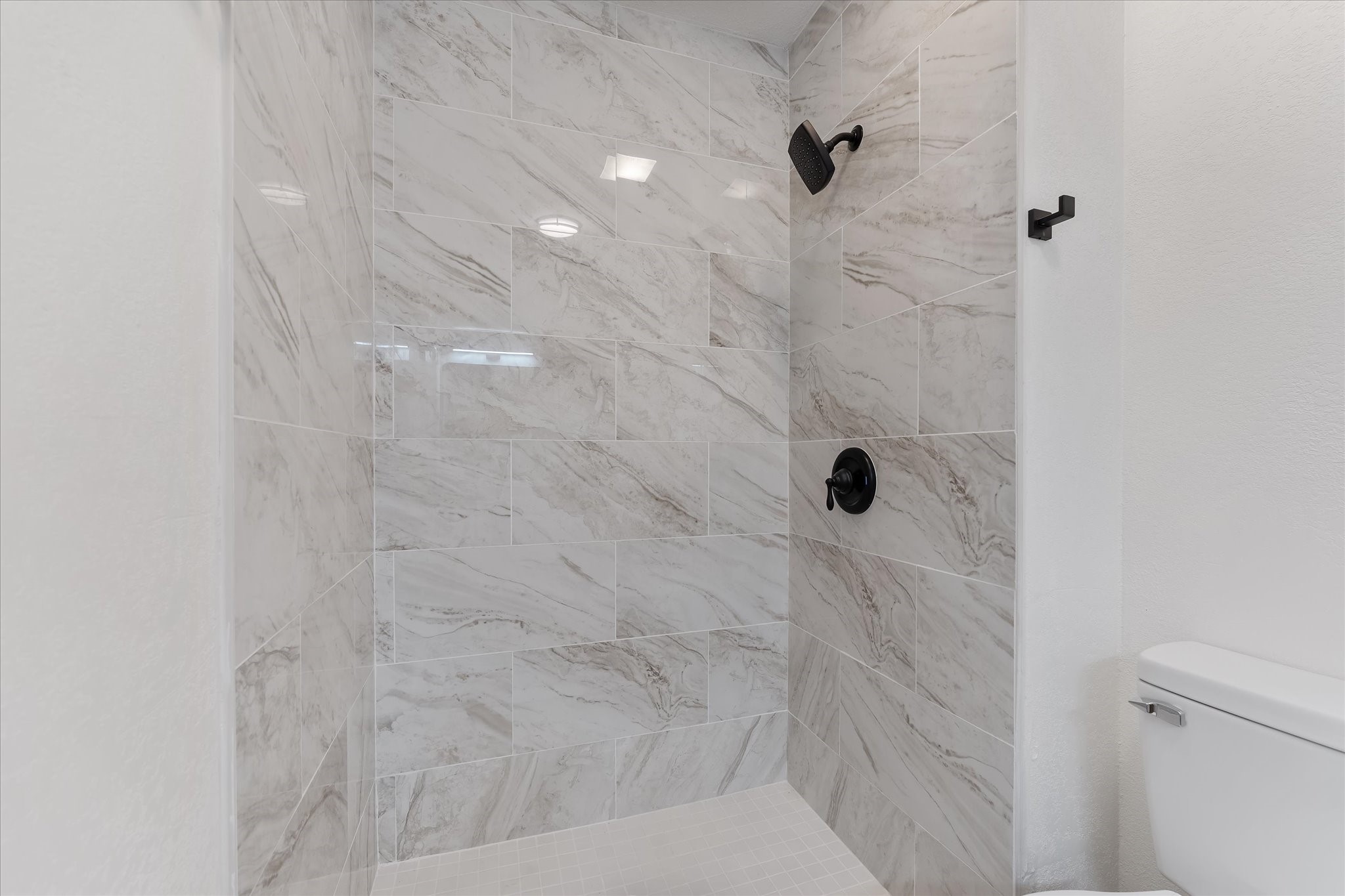 4915 Andrea Street Houston, TX 77021 - Photo 12 of 19 Secondary bathroom featuring a walk-in shower with gorgeous tile walls.