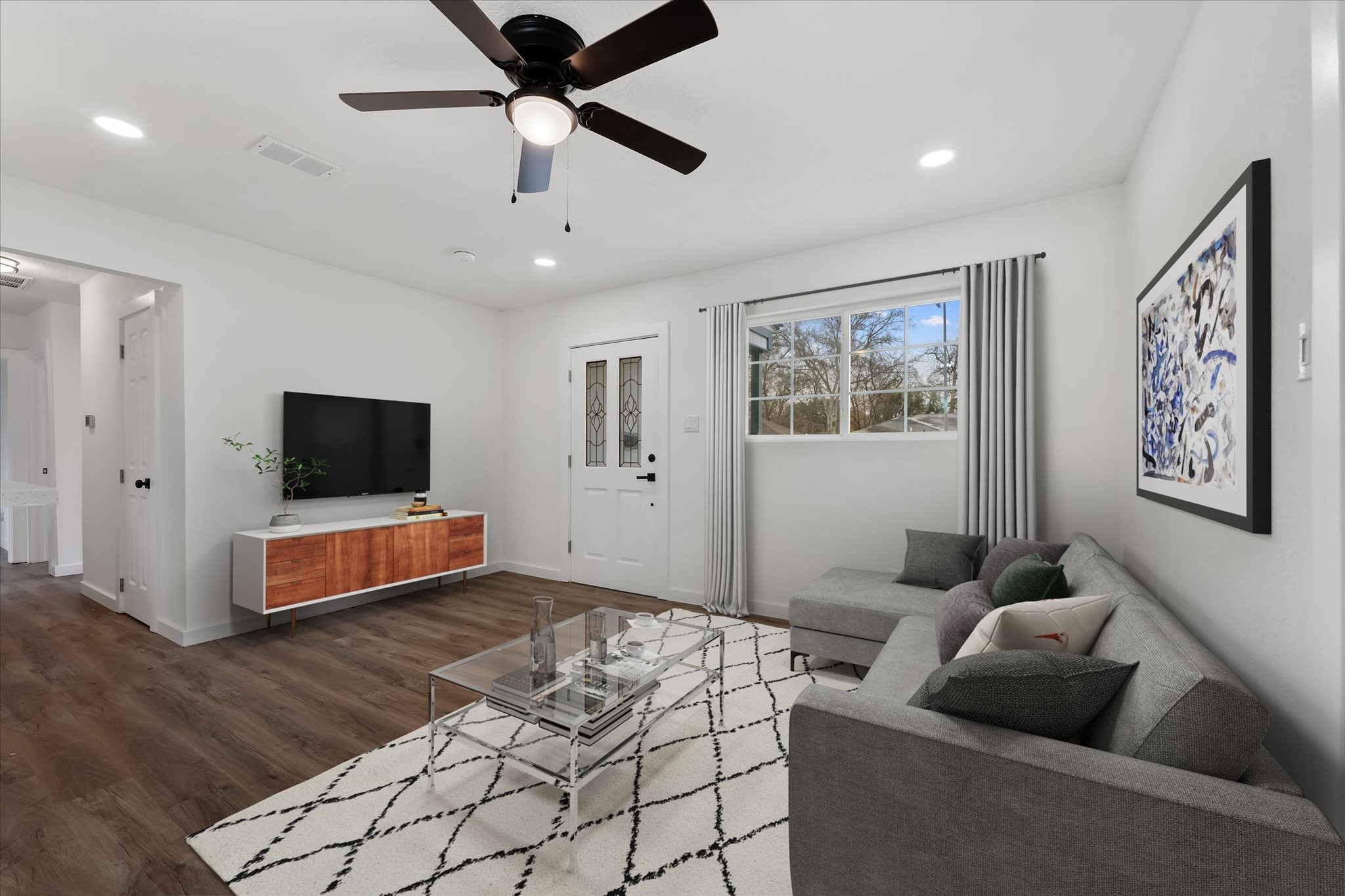 4915 Andrea Street Houston, TX 77021 - Photo 3 of 19 Virtually Staged: This stunning living room features vinyl plank floors, recessed lighting, and a ceiling fan.