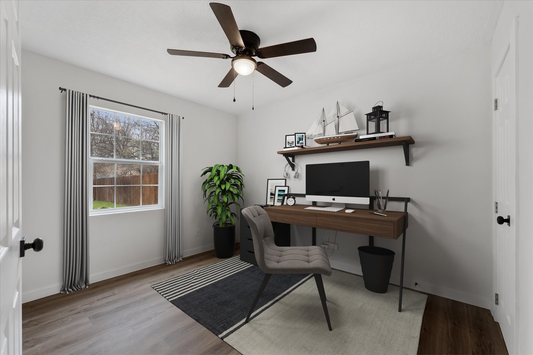 4915 Andrea Street Houston, TX 77021 - Photo 8 of 19 Virtually Staged: This space if flexible! It can be a great fit for a home office or a secondary bedroom! Featuring vinyl plank floors, a large window, and a ceiling fan.
