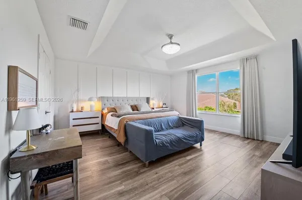 a bedroom with a bed and a lamp