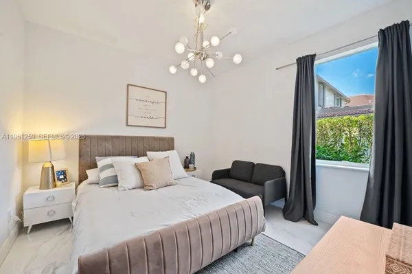 a bedroom with a bed and a desk