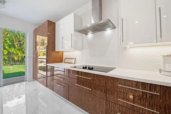 a kitchen with cabinets a sink and appliances