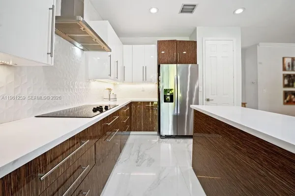 a kitchen with stainless steel appliances sink refrigerator and microwave