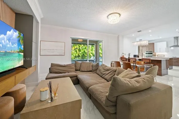 a living room with furniture and a chandelier
